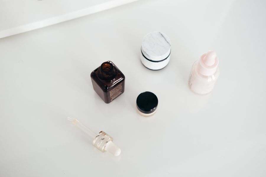 Natural personal-care bottles arranged on linen in soft daylight.