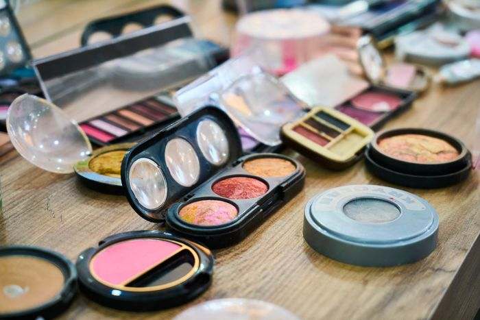 Open makeup palettes photographed from above.